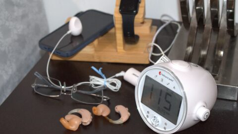 DSC_0019 small round clock on night table with hearing aid, glasses cell phone and watch